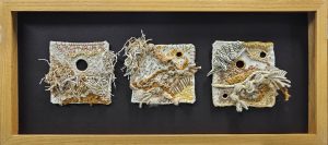 Stitched fiber on wool, mounted in wood frame